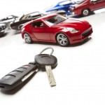 Car Keys and Several Sports Cars on White Background.